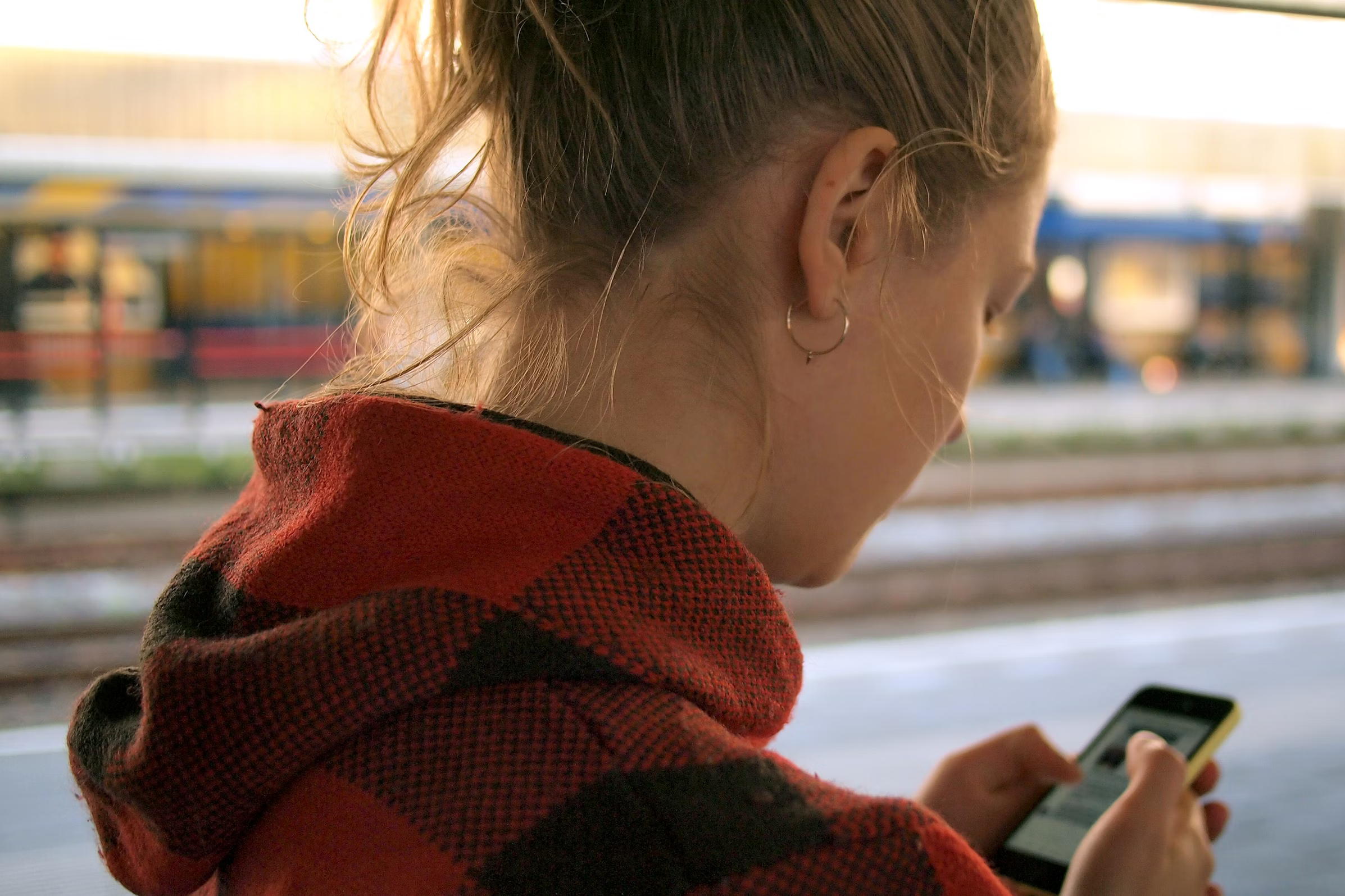 A young user looks at a smartphone. Children, youth, social media.