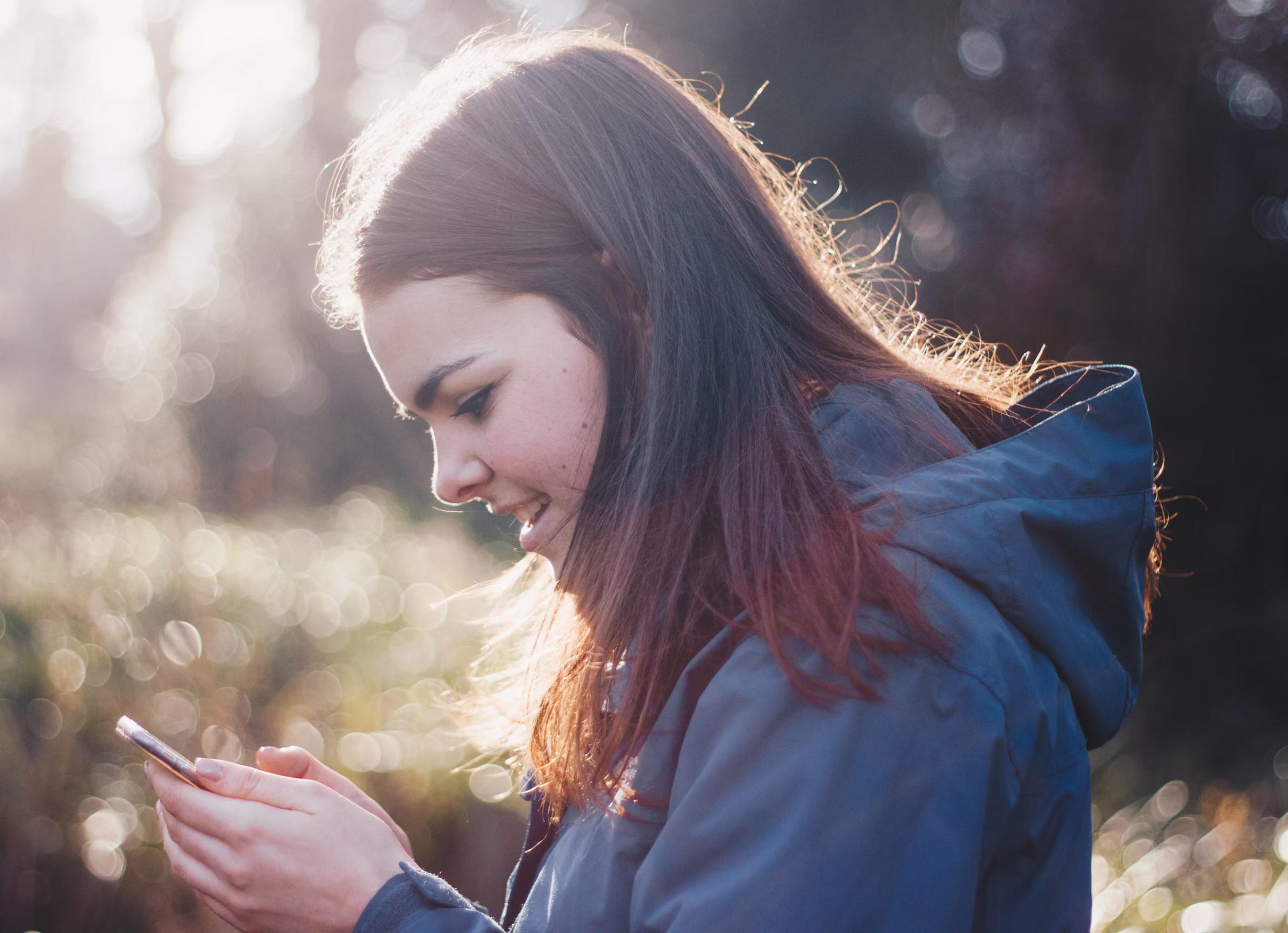 A young user looks at a smartphone. Children, youth, social media.